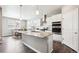Bright kitchen with granite island, white cabinets, stainless steel appliances, and adjacent dining area at 8888 Falcon St, Longmont, CO 80504
