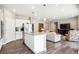 Open kitchen with stainless steel appliances, granite island, leading to a cozy living room at 8888 Falcon St, Longmont, CO 80504