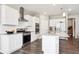 Bright kitchen with white cabinets, stainless steel appliances, granite counter tops, and center island at 8888 Falcon St, Longmont, CO 80504