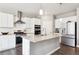 Bright kitchen with white cabinets, stainless steel appliances, granite counter tops, and center island at 8888 Falcon St, Longmont, CO 80504