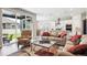 Open concept living room featuring backyard view, seamless flow into the bright kitchen with barstool seating at 8888 Falcon St, Longmont, CO 80504