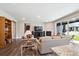 Open living room with hardwood floors, fireplace, and sliding glass doors leading to outdoor patio at 8888 Falcon St, Longmont, CO 80504