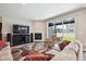 Bright living room with hardwood floors, fireplace, and sliding glass doors leading to outdoor patio at 8888 Falcon St, Longmont, CO 80504
