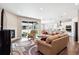 Open-concept living room with fireplace, sliding glass doors to patio, and seamless flow into the bright kitchen at 8888 Falcon St, Longmont, CO 80504