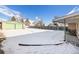 Spacious backyard with detached garage, covered patio, and snow-covered ground at 7674 Stuart St, Westminster, CO 80030