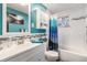 Bathroom with teal walls, white subway tile, and a shower/tub combo at 7674 Stuart St, Westminster, CO 80030