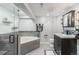 Basement bathroom with walk-in shower, corner soaking tub, and dark vanity at 7674 Stuart St, Westminster, CO 80030