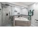 Basement bathroom with a large walk-in shower and corner bathtub at 7674 Stuart St, Westminster, CO 80030