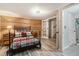 Spacious basement bedroom with wood-paneled wall and access to other rooms at 7674 Stuart St, Westminster, CO 80030