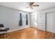 Bedroom with hardwood floors, built-in wardrobe, and ceiling fan at 7674 Stuart St, Westminster, CO 80030