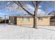 Ranch style home with brick exterior, front door, and snowy yard at 7674 Stuart St, Westminster, CO 80030