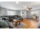 Living room with hardwood floors, sectional sofa, and entryway at 7674 Stuart St, Westminster, CO 80030