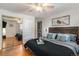 Main bedroom with hardwood floors, mirrored closet, and king bed at 7674 Stuart St, Westminster, CO 80030