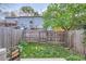 Fenced backyard with some green lawn and view of neighboring townhomes at 8136 Washington St # 141, Denver, CO 80229