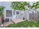 Backyard patio and building exterior with lawn and garden area at 8136 Washington St # 141, Denver, CO 80229