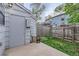 Enclosed backyard featuring gray utility shed and partial lawn at 8136 Washington St # 141, Denver, CO 80229