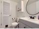 Bathroom featuring a white vanity, a round mirror, and a shower and bathtub combination at 8136 Washington St # 141, Denver, CO 80229