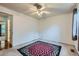 Bright bedroom featuring a ceiling fan and a unique flower-patterned rug at 8136 Washington St # 141, Denver, CO 80229
