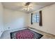 Bedroom with a ceiling fan and a large black, pink, and white rug that gives a contemporary vibe at 8136 Washington St # 141, Denver, CO 80229
