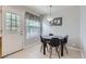 Eat-in kitchen featuring white tile floors, pendant lighting, and an adjacent door to the yard at 8136 Washington St # 141, Denver, CO 80229