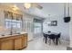 Eat-in kitchen featuring white tile floors, wood cabinets, and double basin stainless steel sink at 8136 Washington St # 141, Denver, CO 80229