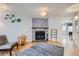 Cozy living room features a stone fireplace, hardwood floors, and unique wall decor at 8136 Washington St # 141, Denver, CO 80229