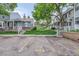 Townhome front facade with landscaping, parking spots, and walkways at 8136 Washington St # 141, Denver, CO 80229