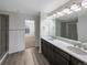 Bathroom with double vanity, large mirror, and a walk-in shower at 3520 Little Bell Dr, Frederick, CO 80516