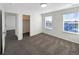 Well-lit bedroom with carpet, two windows, and a closet for storage at 3520 Little Bell Dr, Frederick, CO 80516