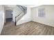 Bright entryway featuring wood-look floors, a staircase with white risers, and plenty of natural light at 3520 Little Bell Dr, Frederick, CO 80516