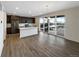 Open-concept kitchen with stainless steel appliances, a center island, and sliding glass doors to the backyard at 3520 Little Bell Dr, Frederick, CO 80516