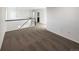 Open landing area with neutral carpet, white walls, and a view to an adjacent bathroom at 3520 Little Bell Dr, Frederick, CO 80516