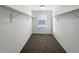Walk-in closet with carpet, a window, and clothing racks along both sides at 3520 Little Bell Dr, Frederick, CO 80516