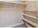 Bright walk-in closet featuring ample storage space with shelving and hanging rods at 610 S Clinton St # 3D, Denver, CO 80247