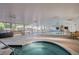 Spacious indoor pool area featuring a pool, hot tub, benches, and floor-to-ceiling windows at 610 S Clinton St # 3D, Denver, CO 80247