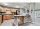 Updated kitchen featuring stainless steel appliances, stone countertops, and a functional breakfast bar at 610 S Clinton St # 3D, Denver, CO 80247