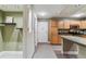 View of kitchen from living area, featuring stainless steel appliances and light wood cabinetry at 610 S Clinton St # 3D, Denver, CO 80247