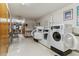Laundry room including several commercial-style washing machines at 610 S Clinton St # 3D, Denver, CO 80247