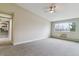 Bright living area with carpet flooring, neutral paint, and a kitchen view, offering an open-concept design at 610 S Clinton St # 3D, Denver, CO 80247