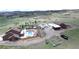 Aerial view of a home showcasing the pool, extensive landscaping, detached garage, and surrounding acreage at 1063 Clarke Ct, Castle Rock, CO 80109