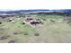 Expansive property featuring a home, outbuildings and barn, set against a scenic landscape at 1063 Clarke Ct, Castle Rock, CO 80109