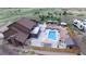 Drone eye view of a backyard pool, patio with furniture, and playground at 1063 Clarke Ct, Castle Rock, CO 80109