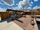 Spacious backyard featuring a covered patio with seating, a built-in grill, and ample space for outdoor activities at 1063 Clarke Ct, Castle Rock, CO 80109