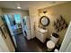 Compact bathroom with stacked washer and dryer and granite-topped vanity at 1063 Clarke Ct, Castle Rock, CO 80109