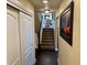 Hallway leading to the upper level with dark hardwood flooring and a decorative painting at 1063 Clarke Ct, Castle Rock, CO 80109