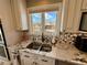 Kitchen sink with stainless steel and granite countertops with a view to the backyard at 1063 Clarke Ct, Castle Rock, CO 80109