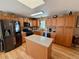Charming kitchen with wood cabinets, stainless appliances, an island, and ample counter space at 1063 Clarke Ct, Castle Rock, CO 80109