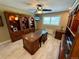 Home office with custom wood built-ins, marble top desk, and bright window at 1063 Clarke Ct, Castle Rock, CO 80109