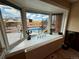 Window view to the backyard pool area with privacy fence and lounge area at 1063 Clarke Ct, Castle Rock, CO 80109