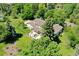 The home is surrounded by mature trees and a fenced in yard at 9678 E Powers Dr, Greenwood Village, CO 80111